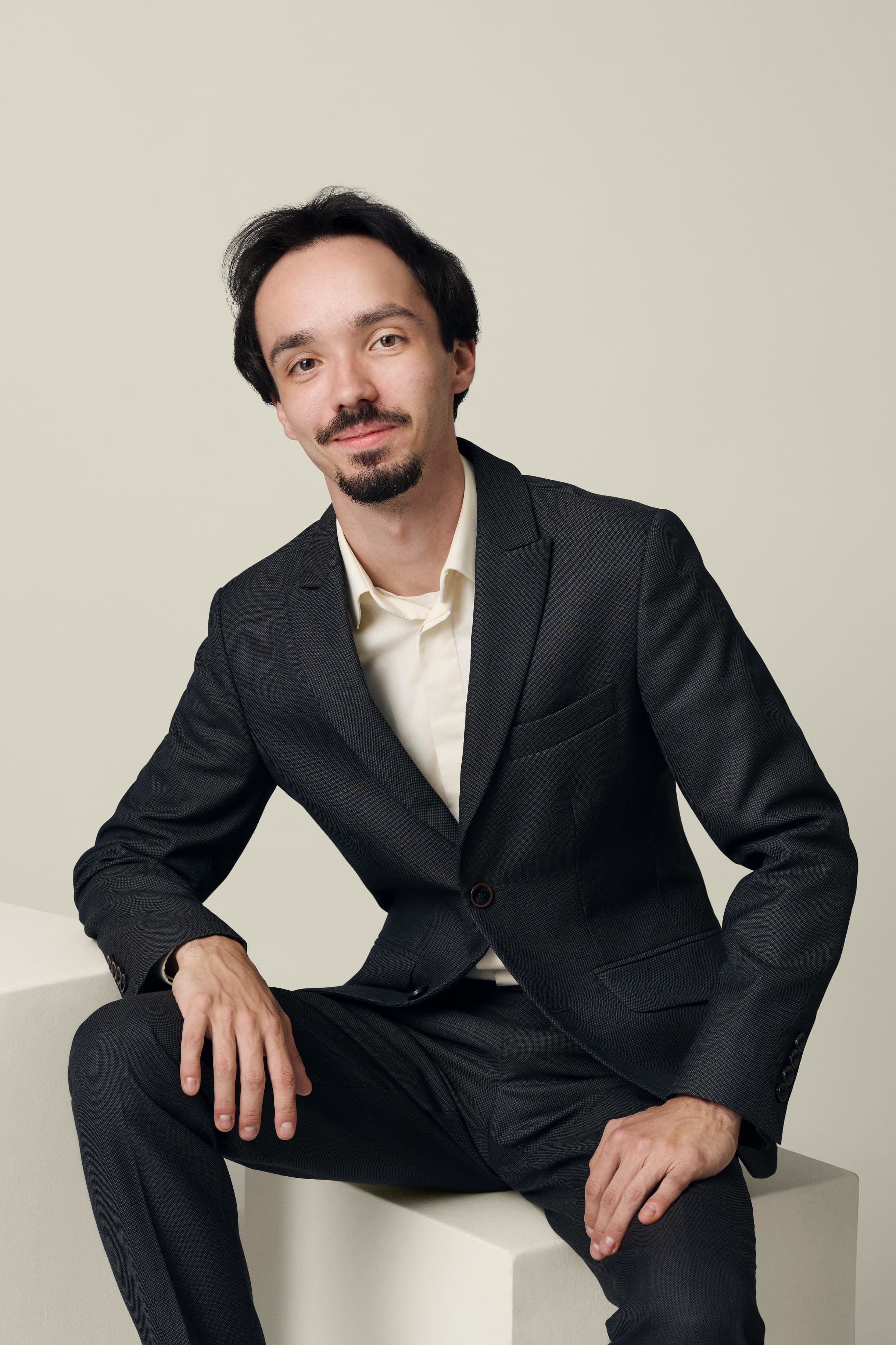 Man with black suit looking directly at the camera