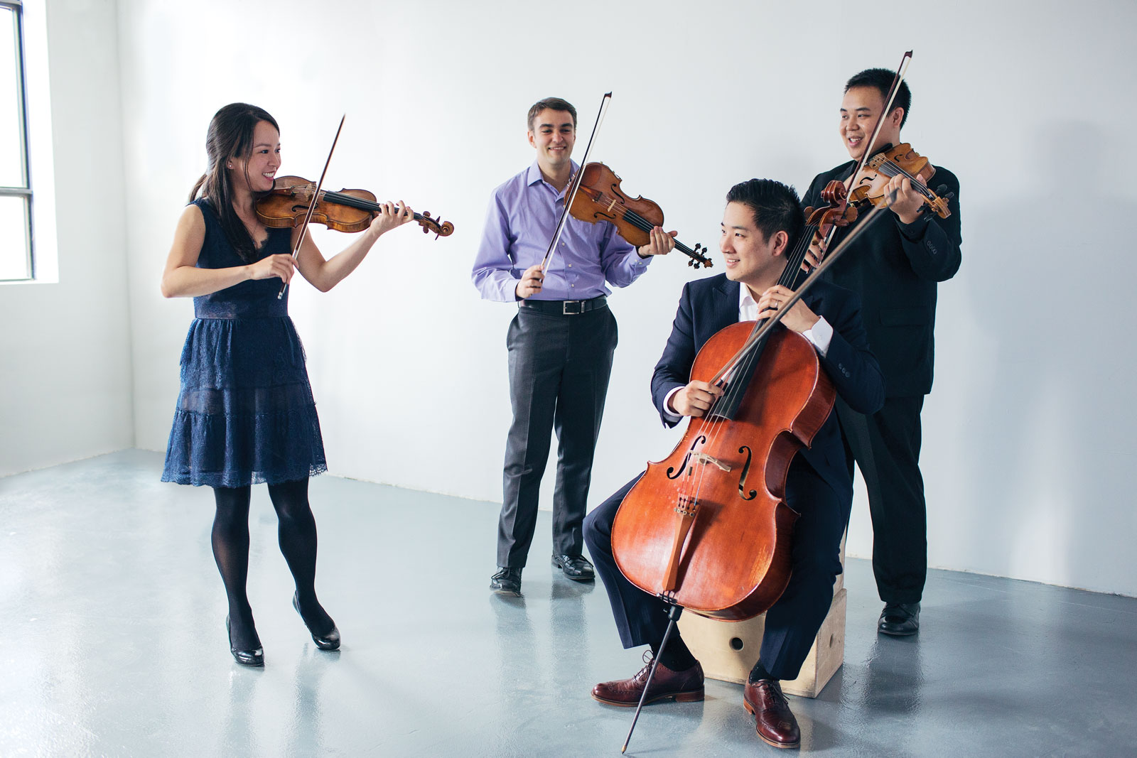 A string quartet poses for a photo