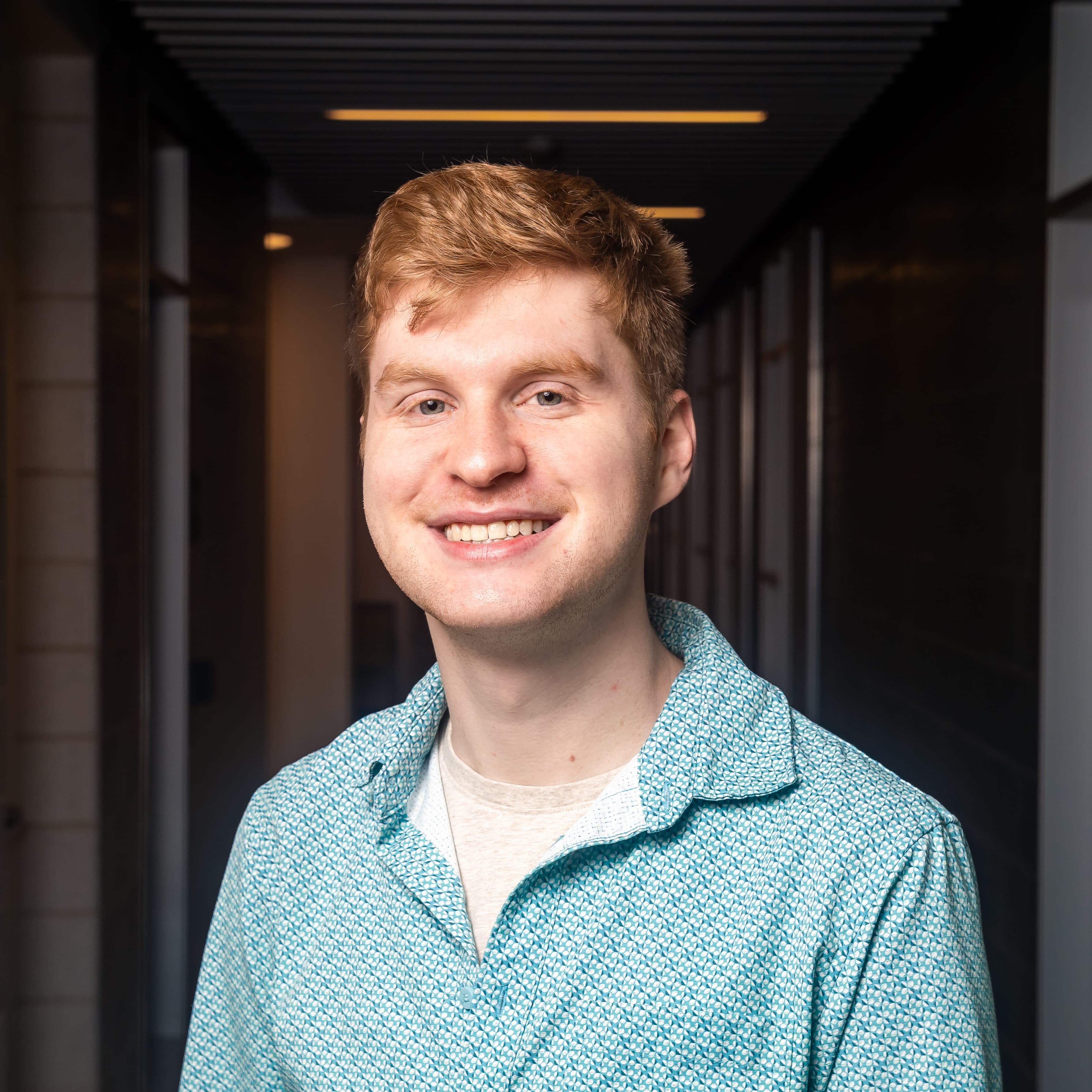Man in blue button-down shirt looking at camera