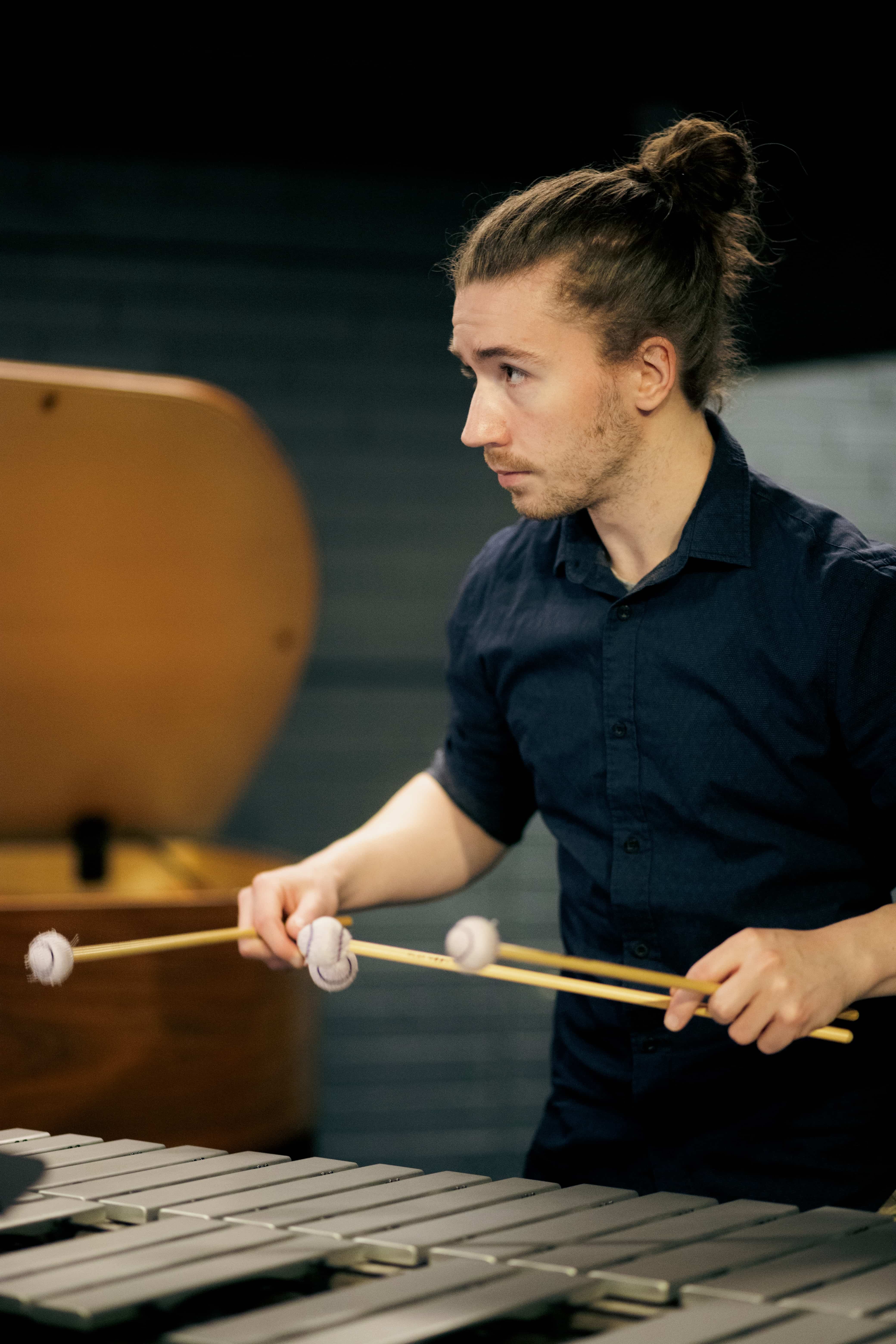 Action shot of Alexander playing percussion instrument