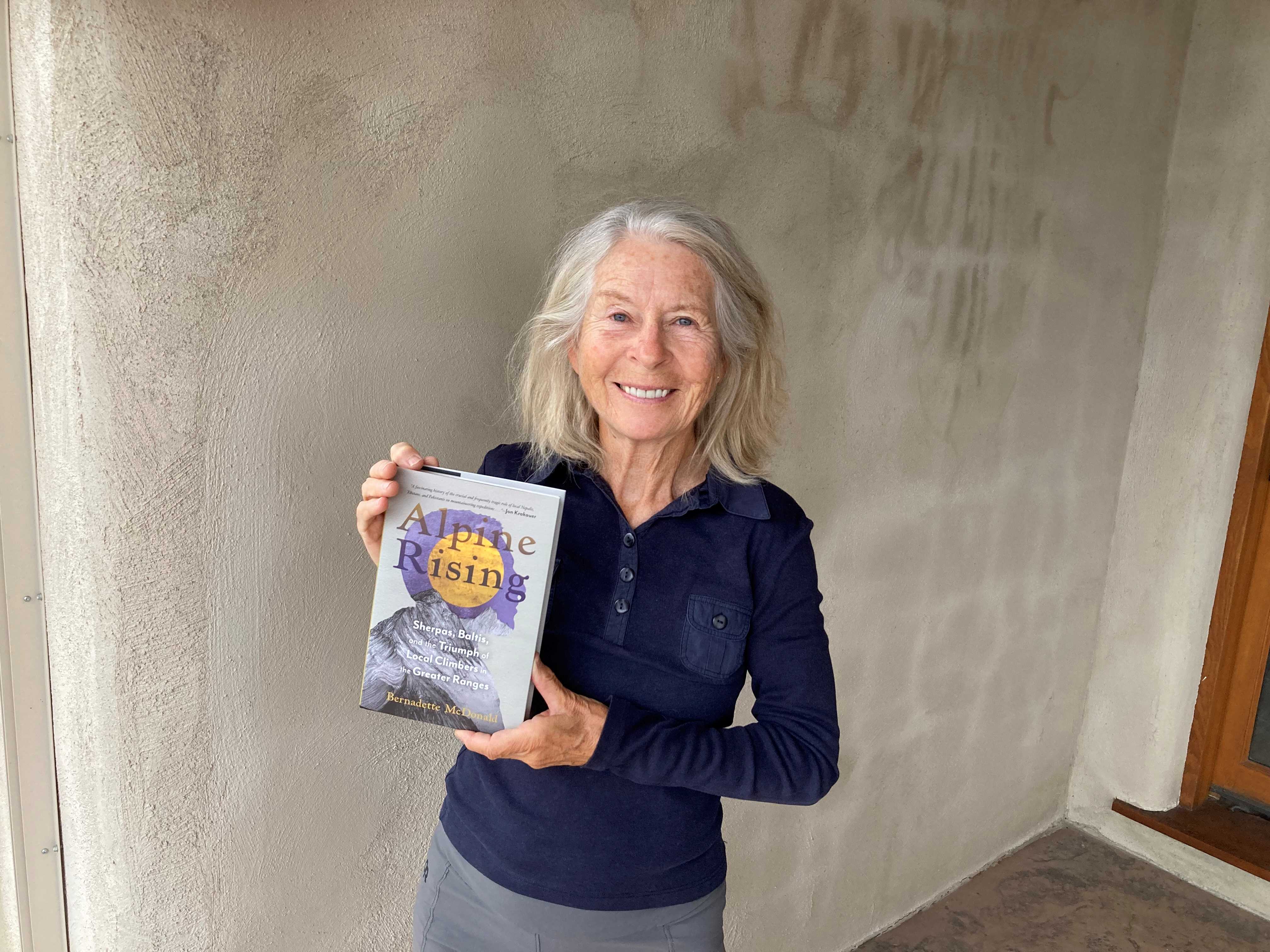 A photo of Bernadette McDonald holding her new book, Alpine Rising.