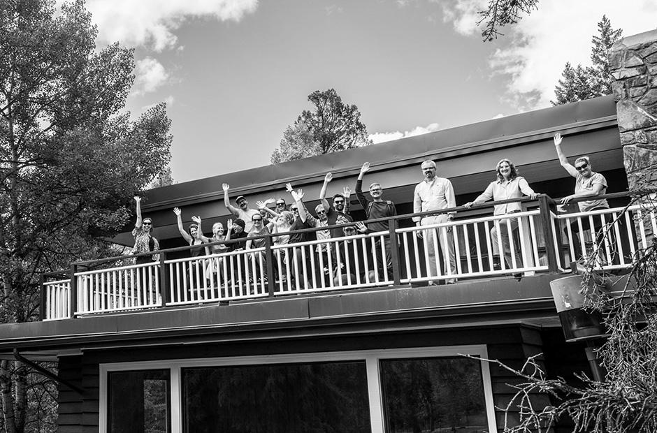 Banff Centre staff waving from the sun deck of Farrally Hall in the summer of 2023