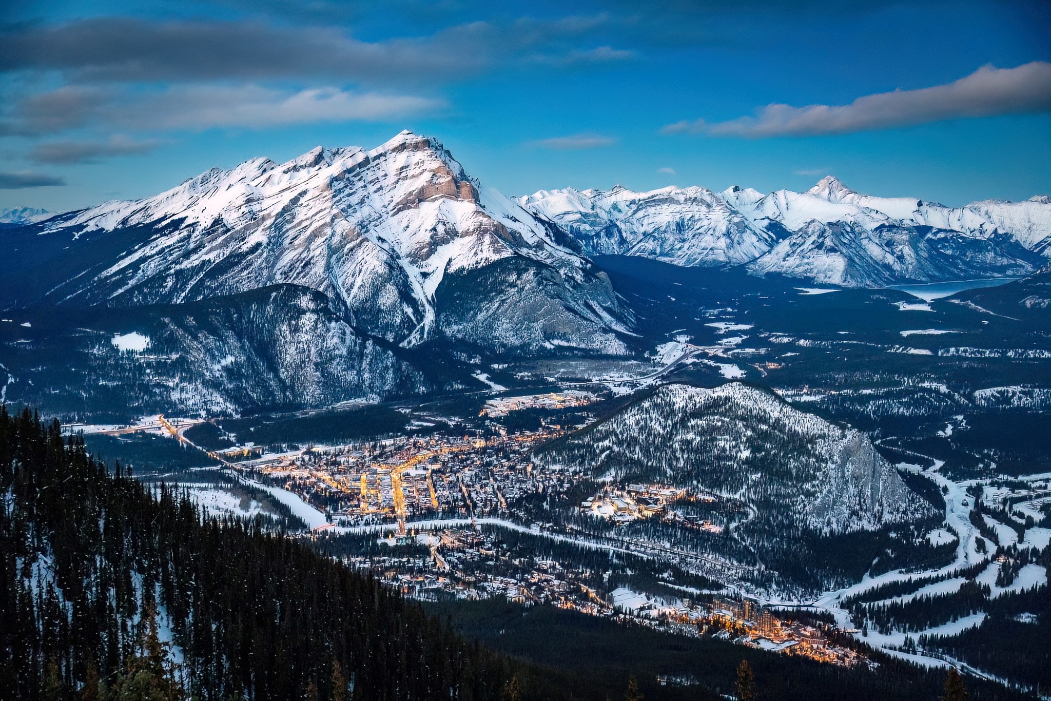 A snow covered Banff is seen from the Sulphur Mtn Gondola above the town to the South-West. It's a cool blue evening and