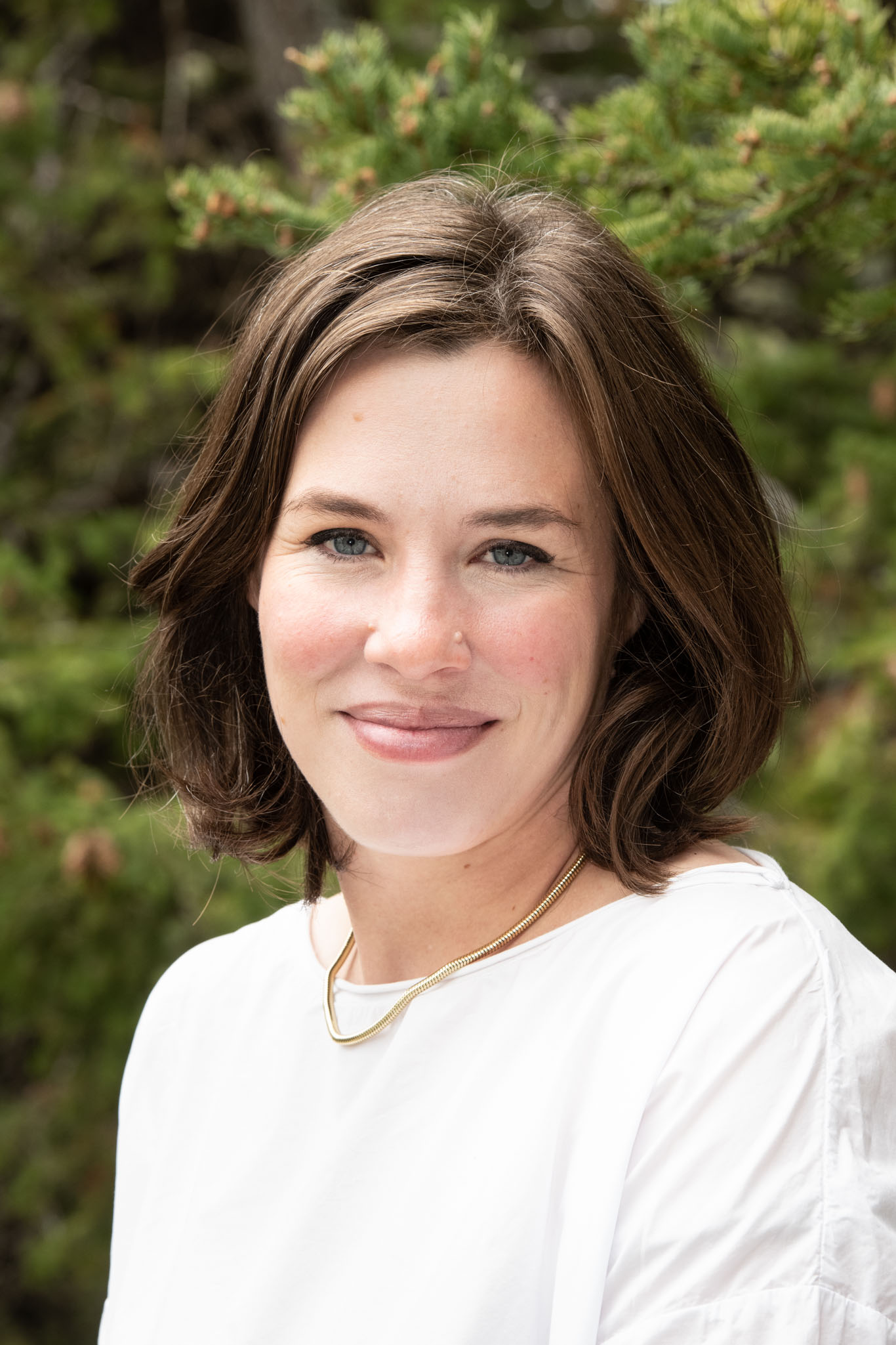 Jacqueline Bell standing outside in summer smiling at camera