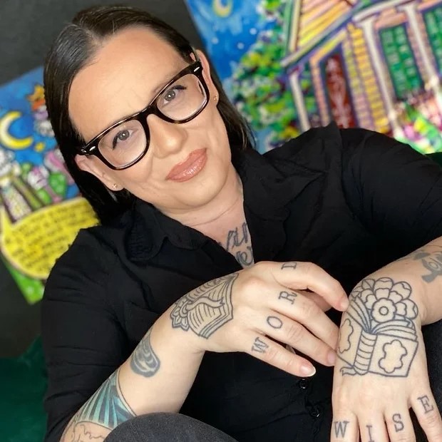 Woman with dark hair and glasses