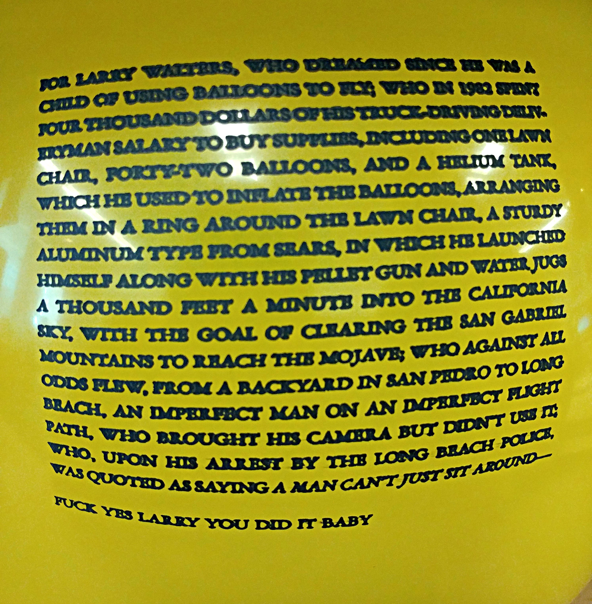 A yellow balloon inflated with a short story printed on it in all caps. 