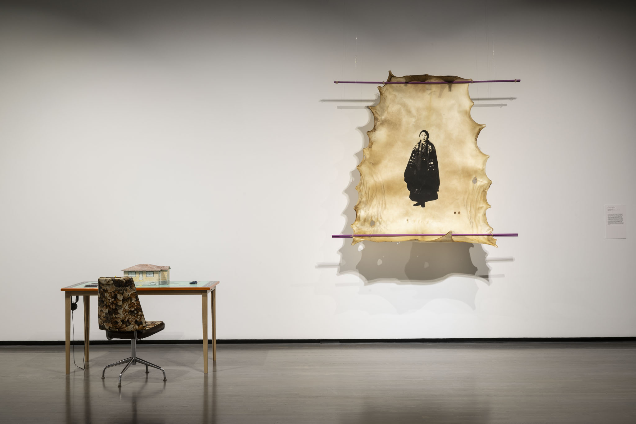 Installation view of Elliptical Lineages, Walter Phillips Gallery, Banff Centre for Arts and Creativity, 2025. From left to right: seth cardinal dodginghorse, nasagha (home), 2025,  courtesy of the artist; tīná gúyáńí, nadisha-hi at’a (I am going home), 2023, courtesy of the artists. Photo: Rita Taylor.