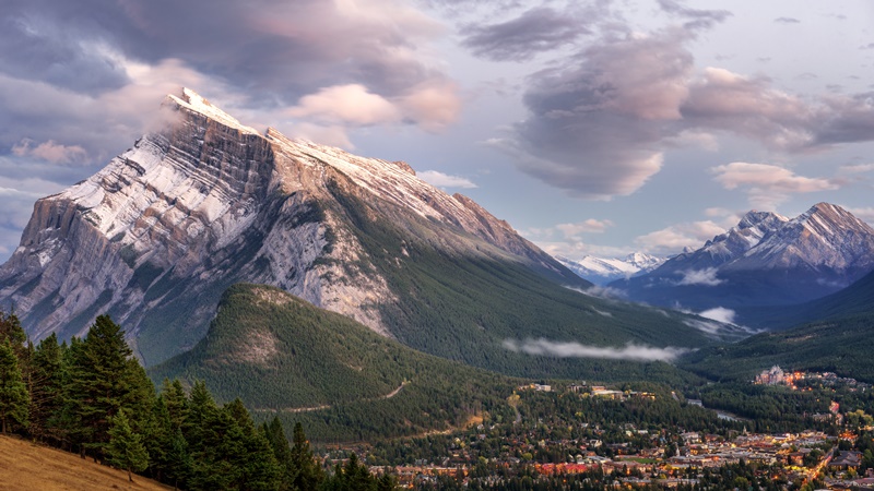 View of Banff from Norquay road. Mount Rundle, Tunnel, and the Spray Valley rise above behind town.