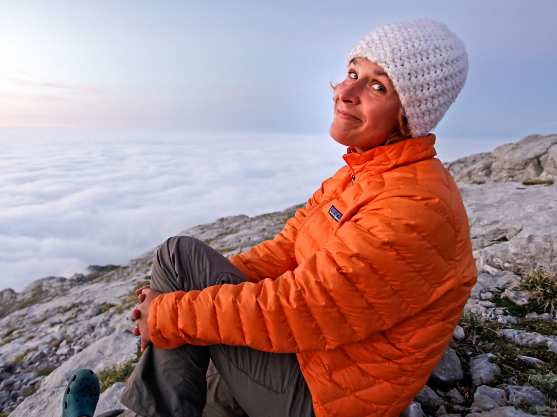 Kasia Biernacka in a orange puffy and white knit hat smiling