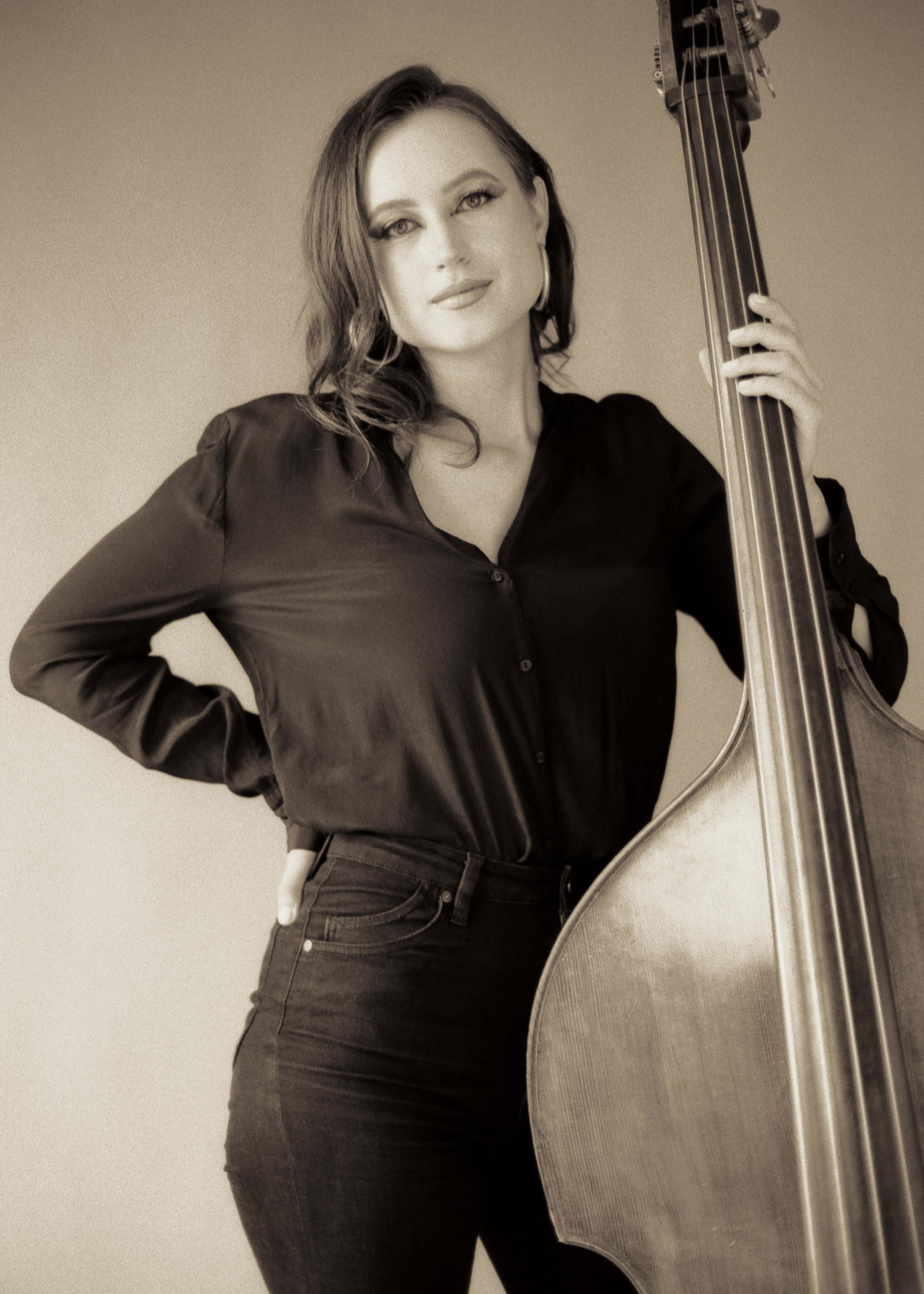 Black and white photo of woman standing with upright bass