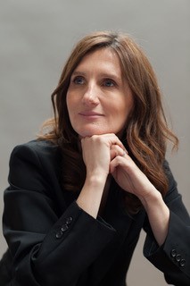 Masha Gordon with brown hair looking off to the side