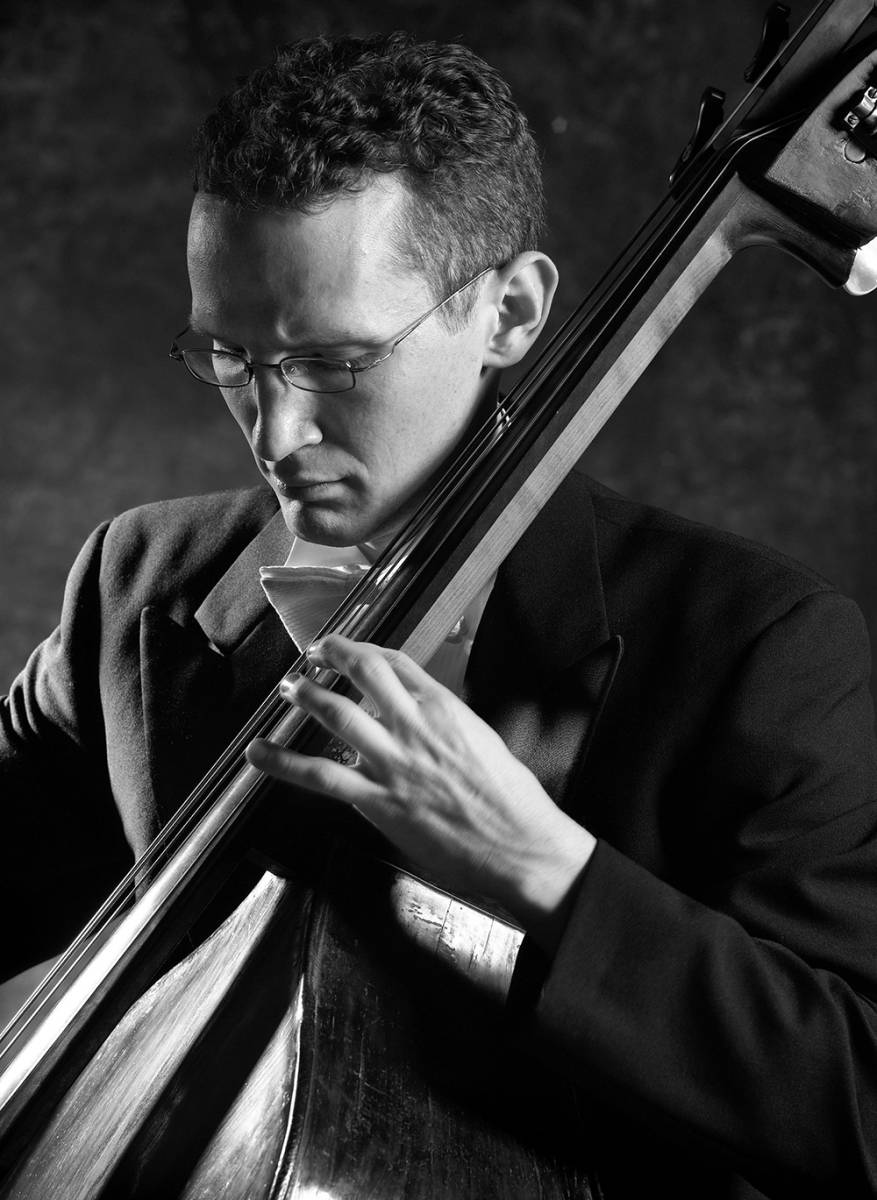 Black and white photo of man playing double bass