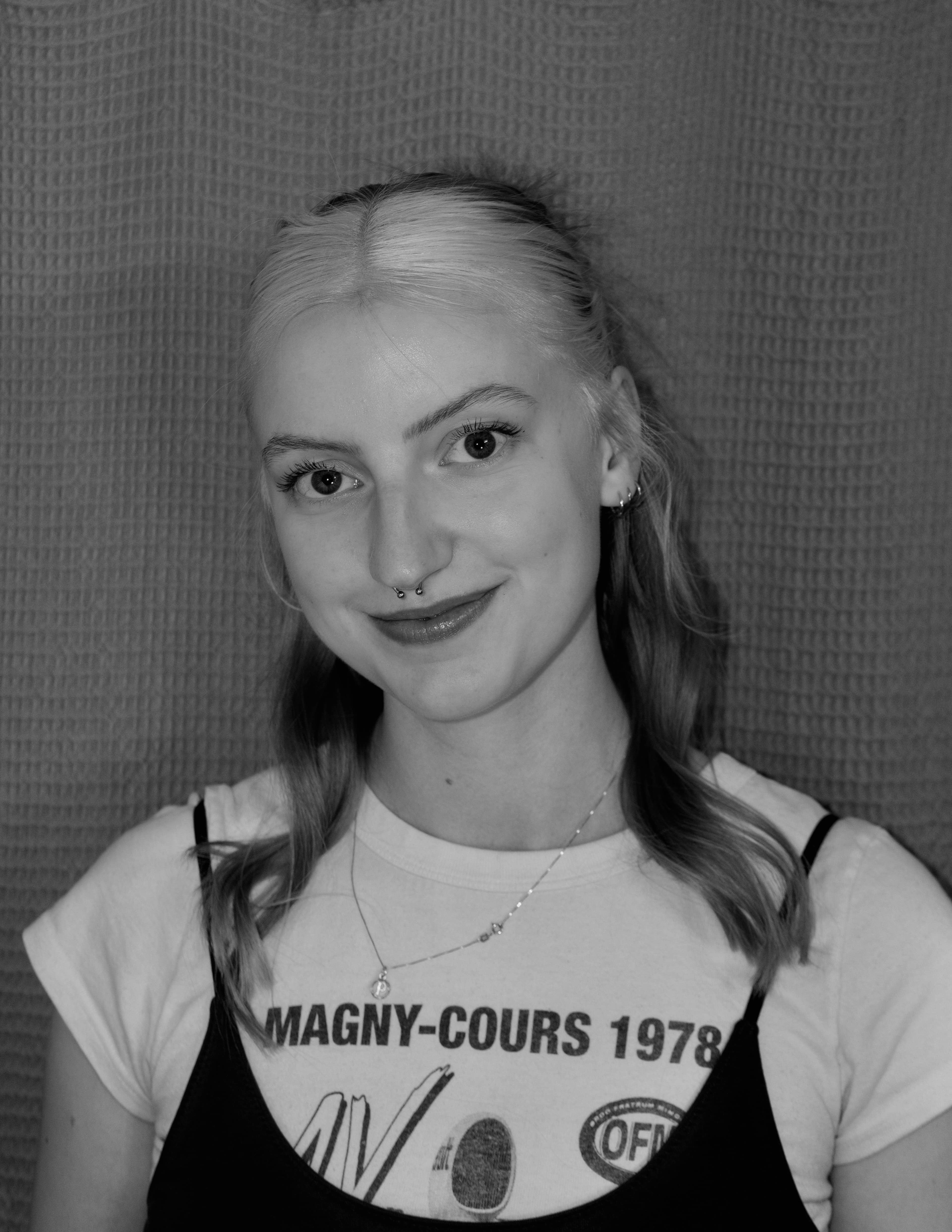Black and white photo of a woman smiling directly at camera