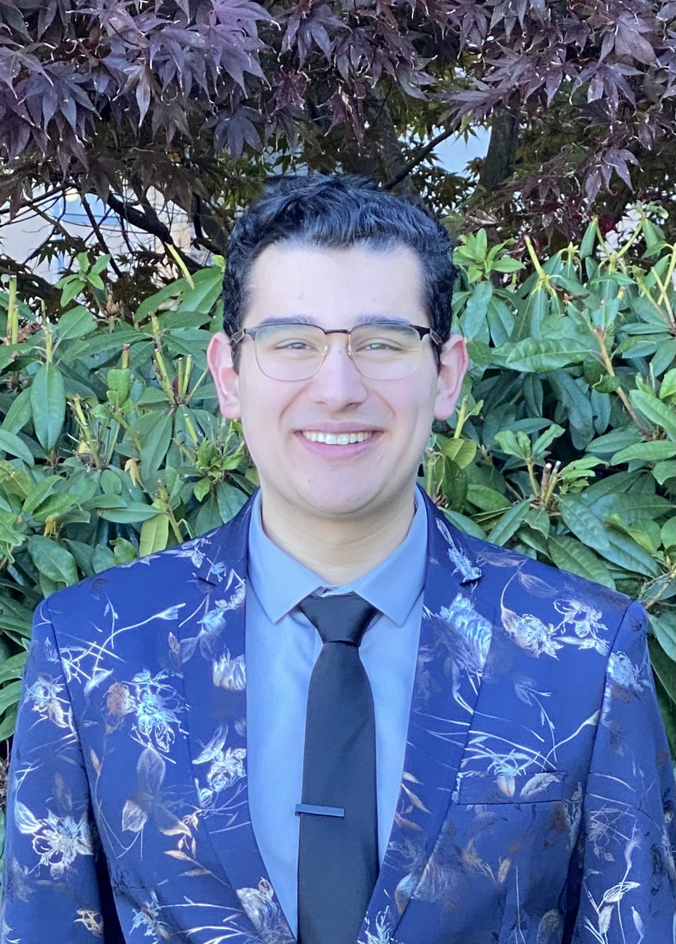 Man smiling at camera in colourful patterned jacket