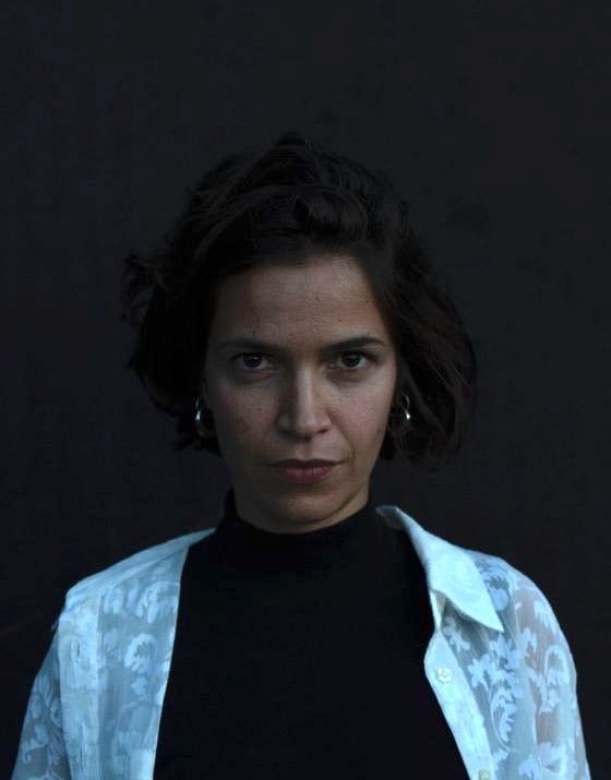 Dark filtered photo of woman staring directly at camera