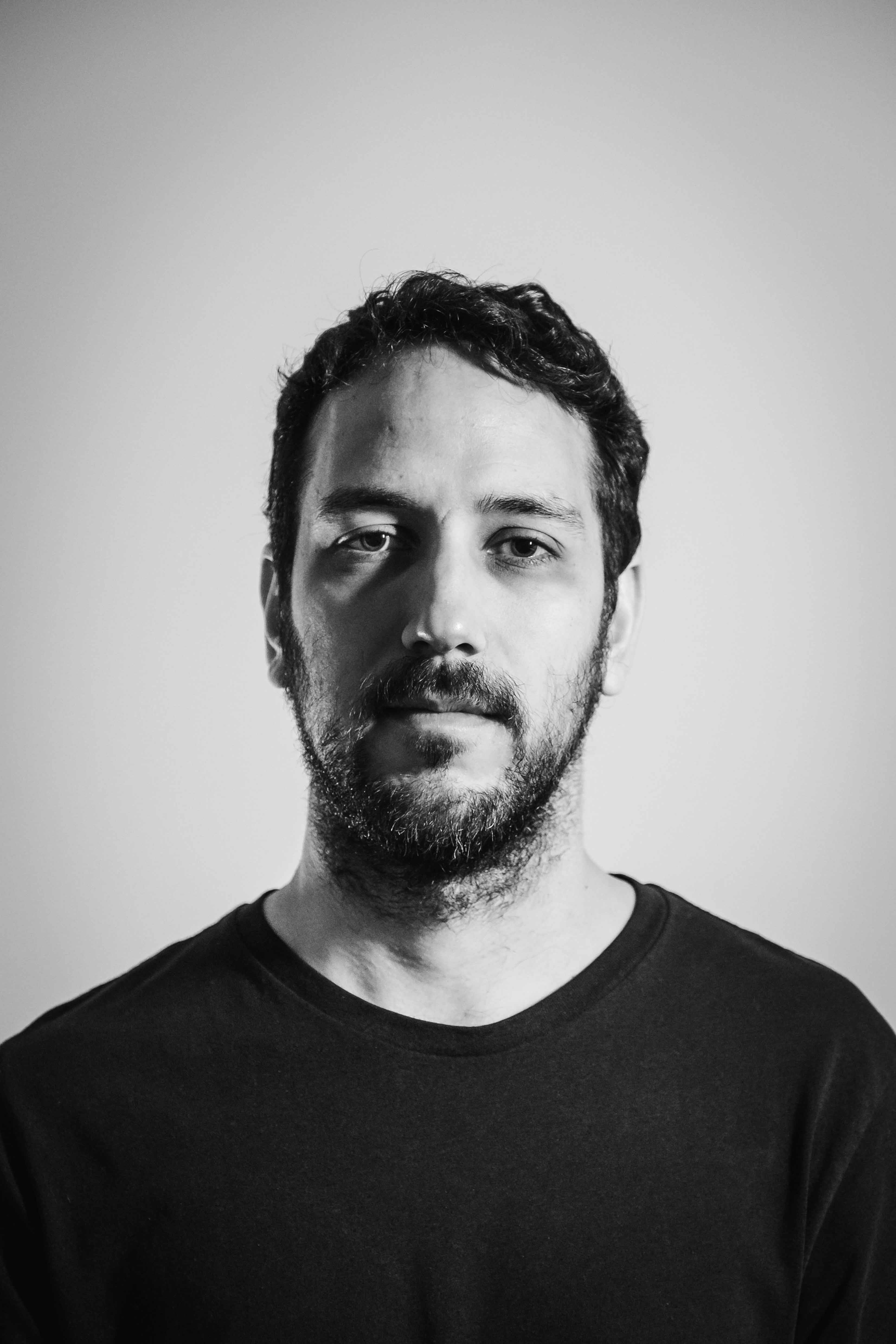 Man with beard looking into the camera