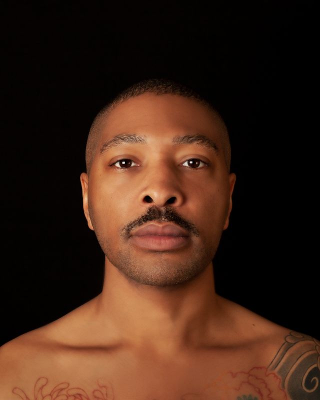 A portrait of Kyle Abraham, bare-chested