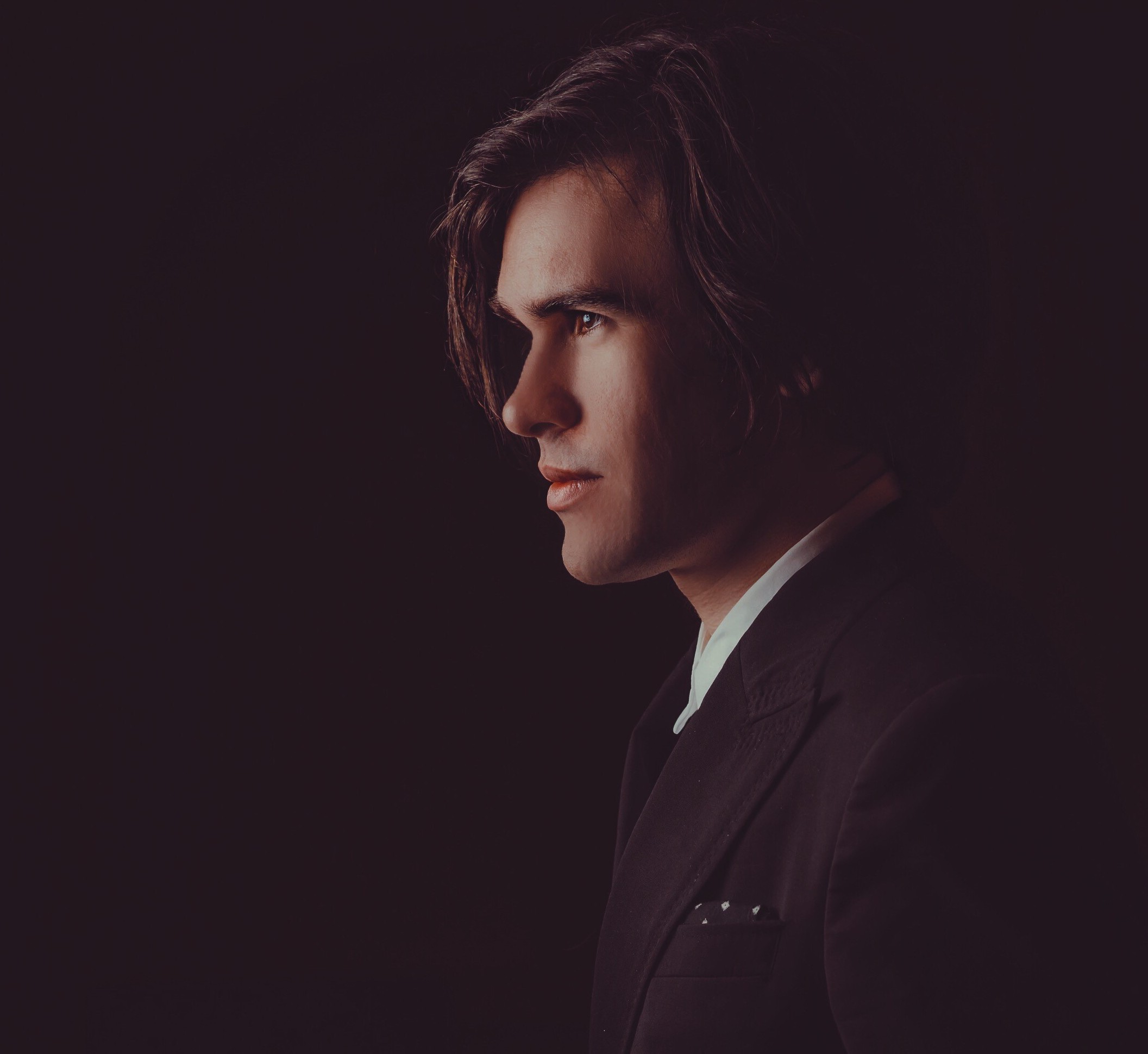 close up of man in suit looking off to the side