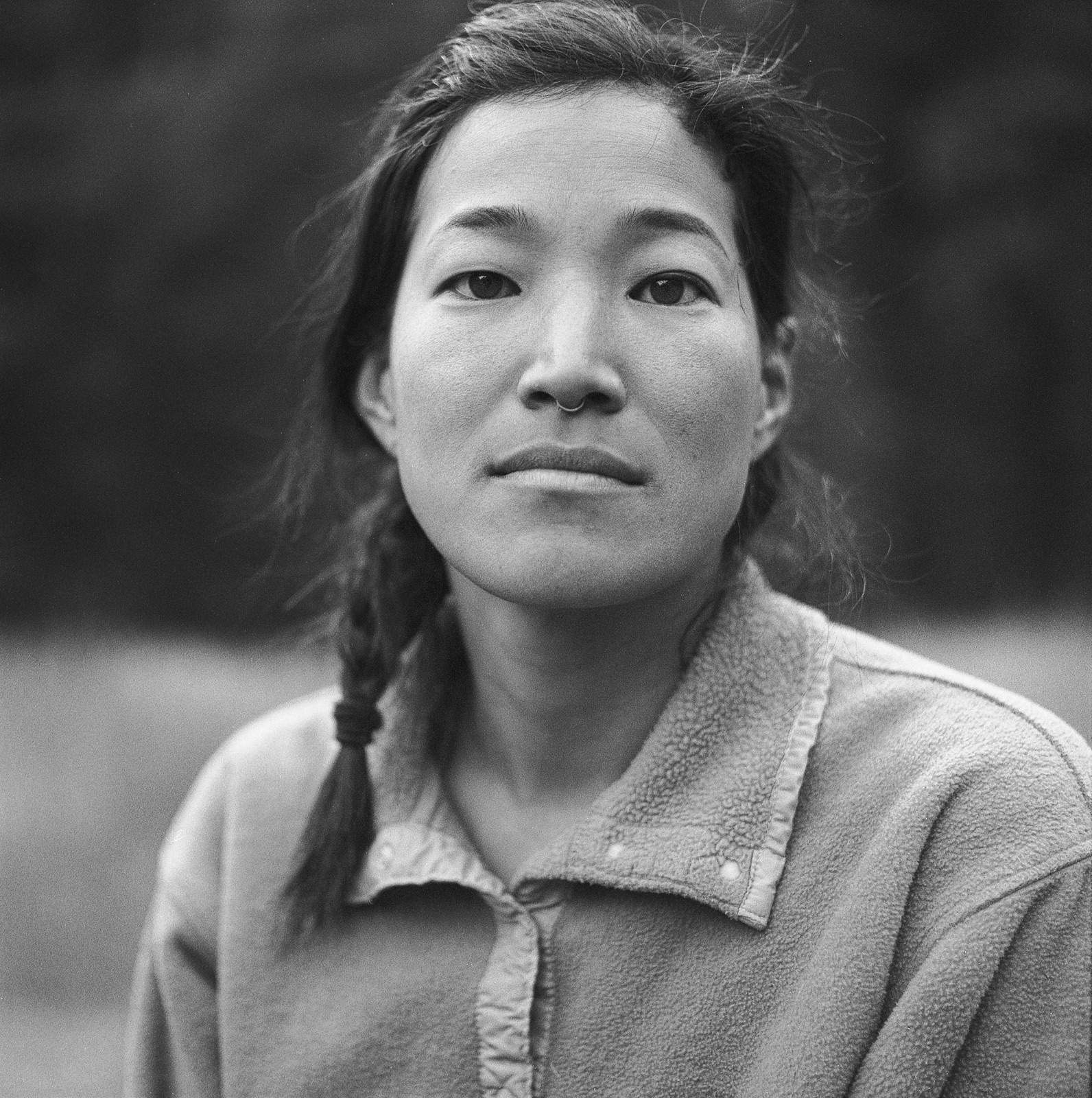 Shelma Jun with braided black hair looks ahead