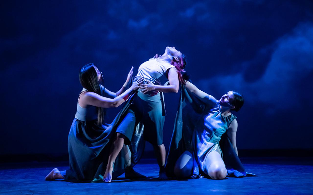 Three dancers perform on stage during the 2022 Intercultural Indigenous Dance Showcase