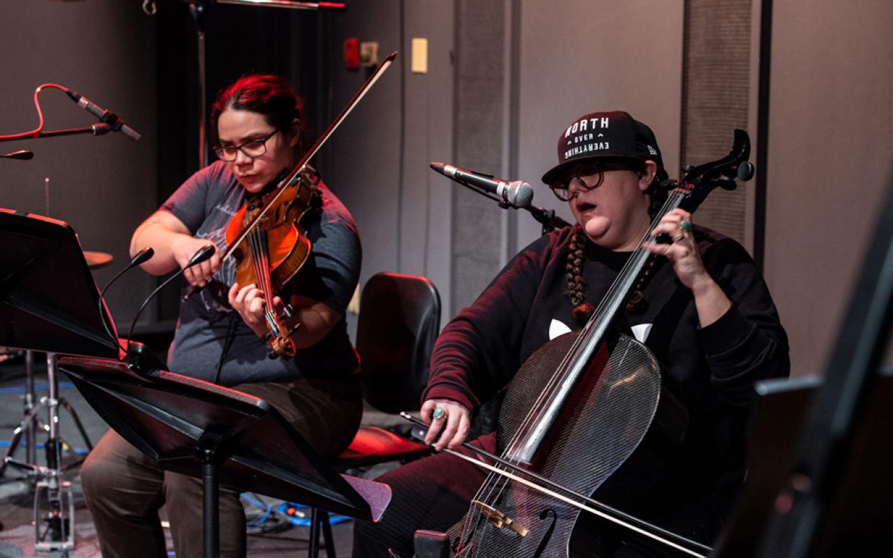 Two musicians performing with string instruments