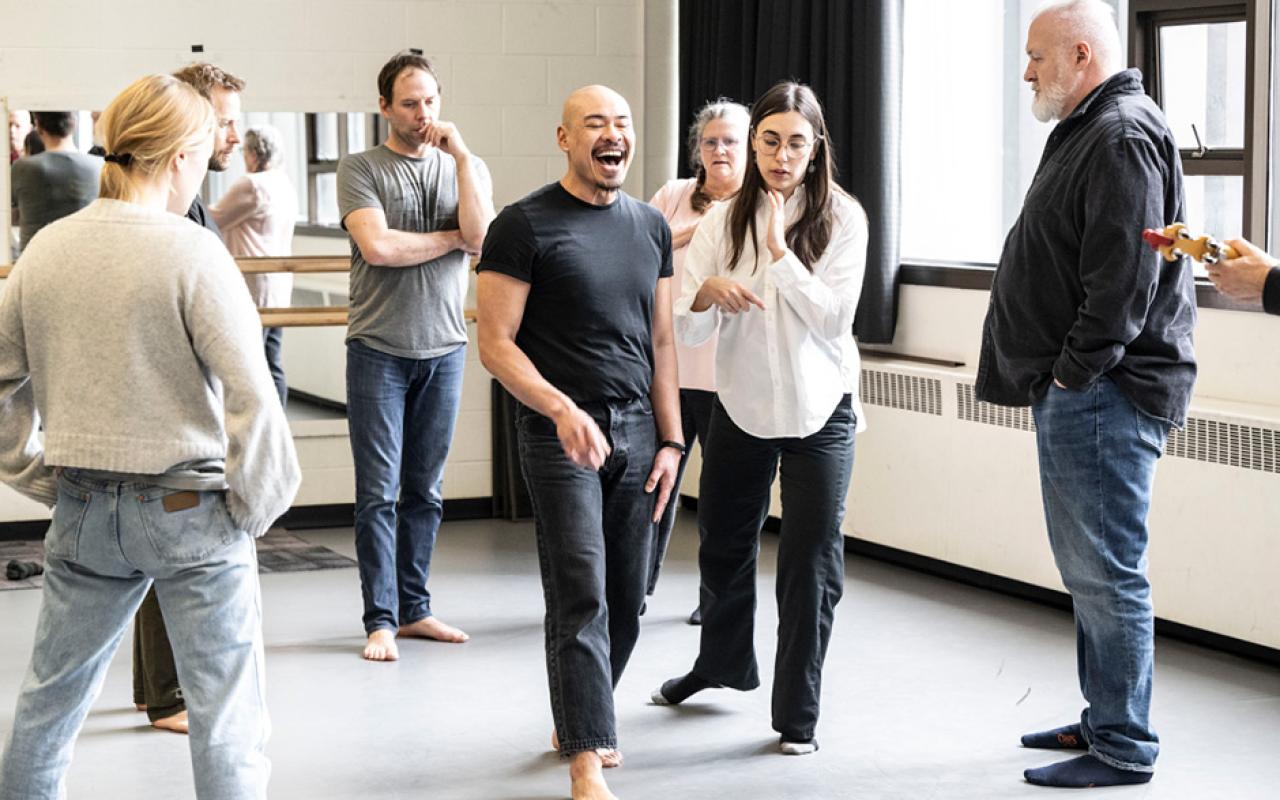 A group of people are rehearsing a play