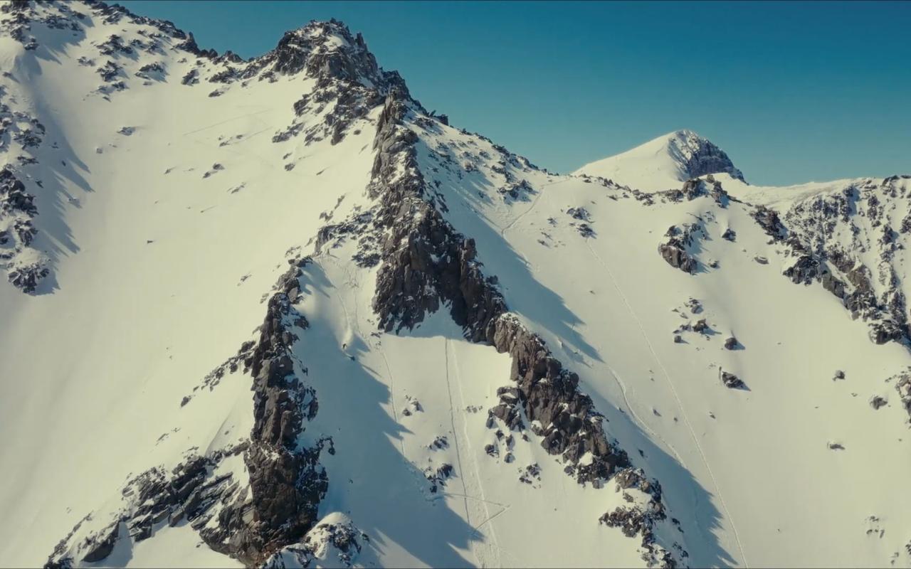 Snow covered mountain peaks and blue sky