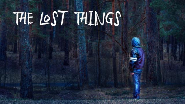 Boy standing facing the woods