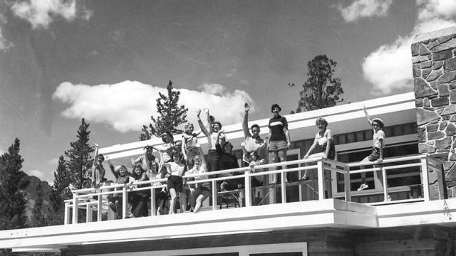 Students waving from the sun deck or Farrally Hall in the summer of 1956