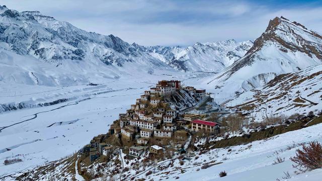 A monastery in snowy mountains.