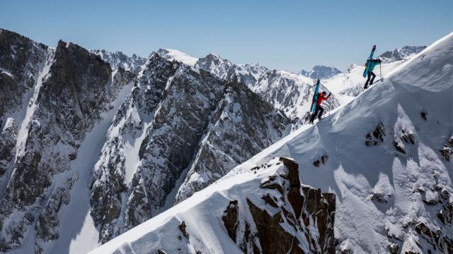 Two skiers climb into the Sierra Nevada backcountry for some ski touring. 