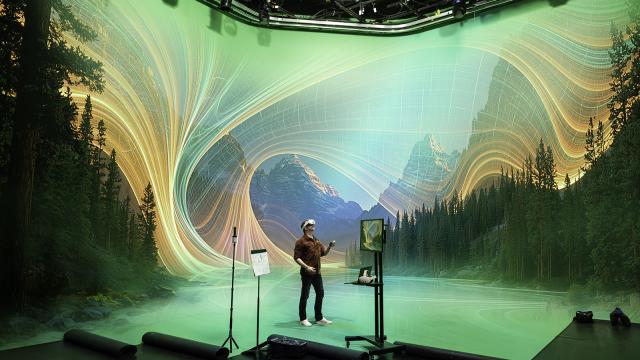 A person standing in a green screen studio wearing a virtual reality headset