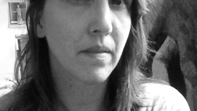 Artist Shannon Bool stares at the camera close-up in a grey-scale photo.