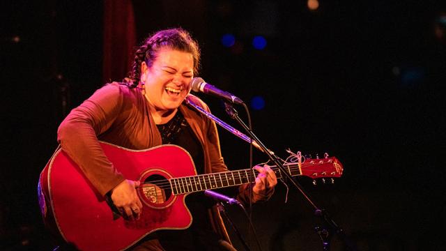 Miranda Currie is pictured singing and playing guitar during a performance at Banff Centre's 2019 Indigenous Arts Singer