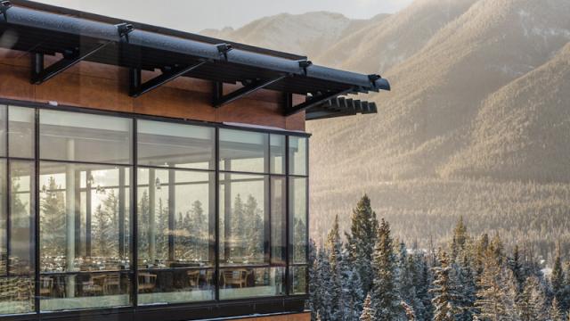 The floor to ceiling windows offer breathtaking views of the mountains.