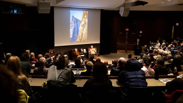 Audience sitting around two speakers at an event in an auditorium at Banff Centre.