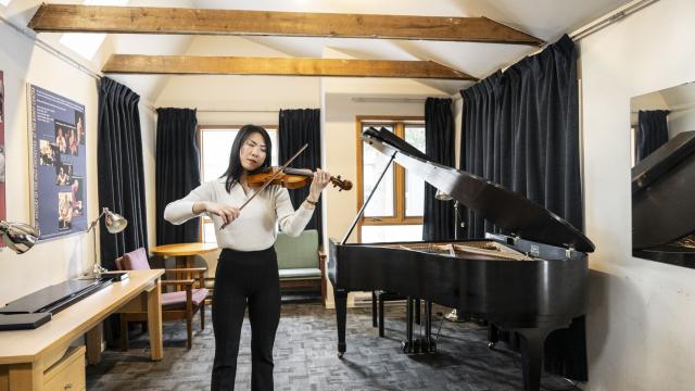 A violinist inside one of the Music Huts at Banff Centre. Photo Credit: Rita Taylor