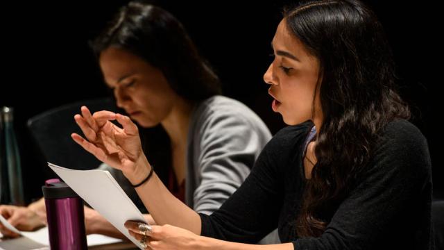 Two actors reading from a script