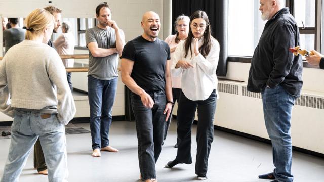 A group of people are rehearsing a play