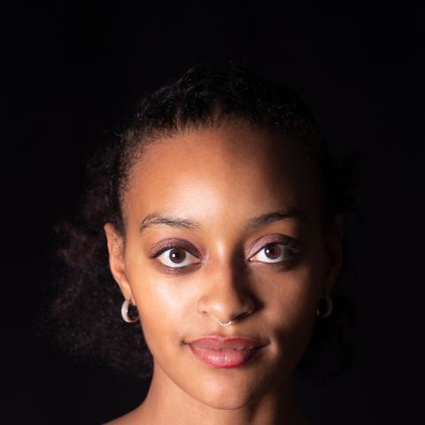 portrait of woman looking directly at camera smiling slightly