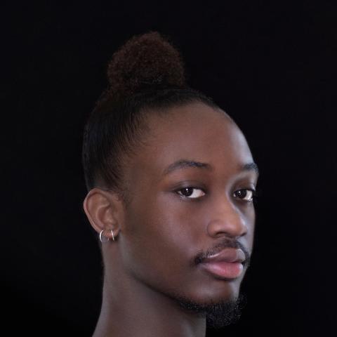 side portrait of dancer with head turned facing camera