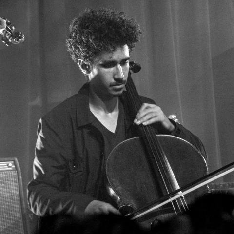 Black and White photo of man playing cello
