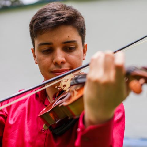 Man in brightly coloured shirt playing violin