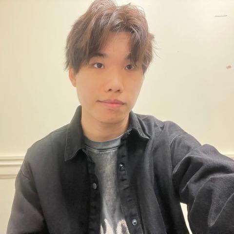 Selfie shot of a young man in casual dress smiling lightly at the camera