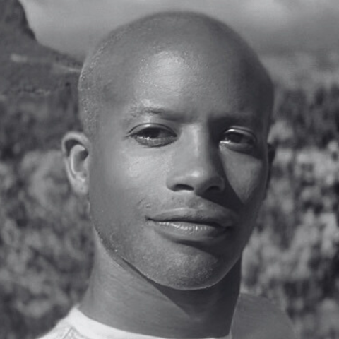 Close up black and white photo of man in nature