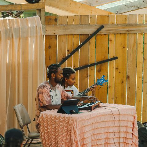 Woman and Man sitting at table with instruments