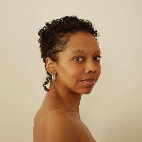 Brown women in a tube, with black curly hair
