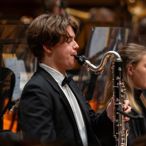 Man playing bass clarinet in concert