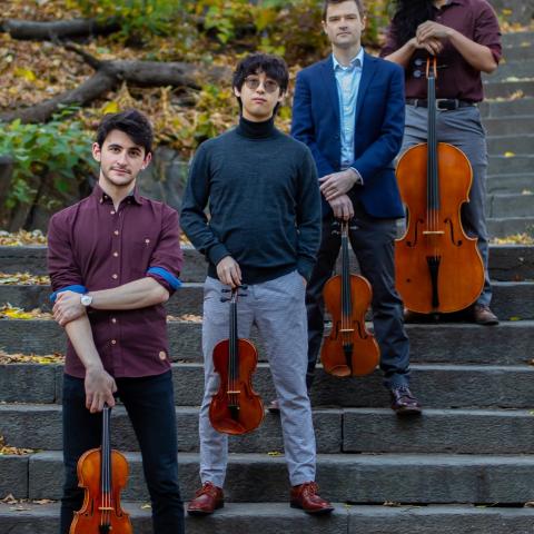 Members of Kodak Quartet standing on stairs with their instruments