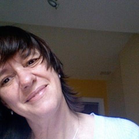 Producer Caroline Holloway tilts her head to the side and smiles